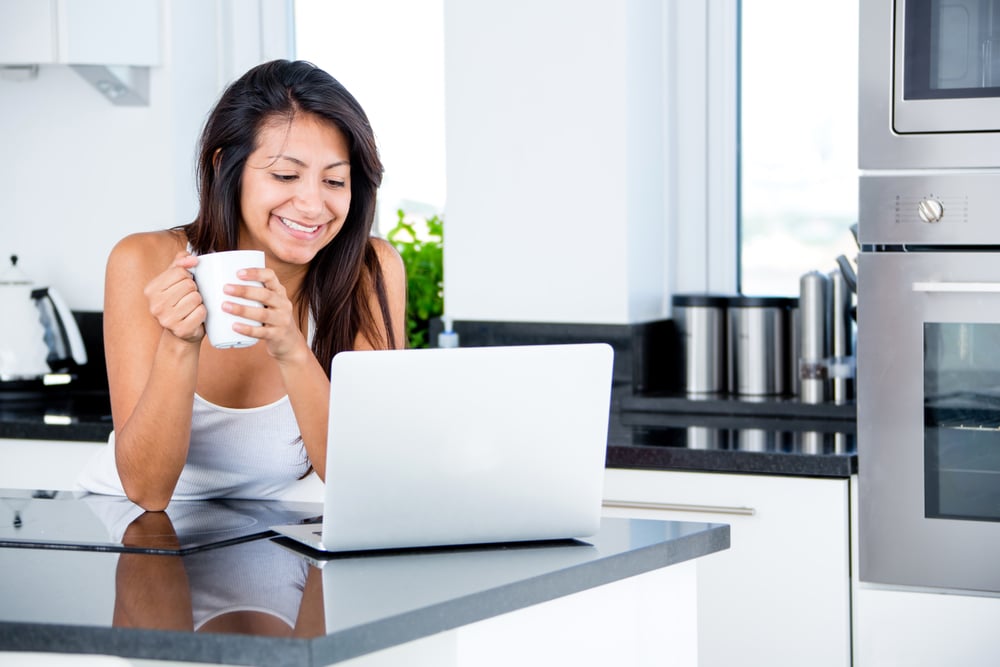 Woman checking her emails in the morning on a laptop